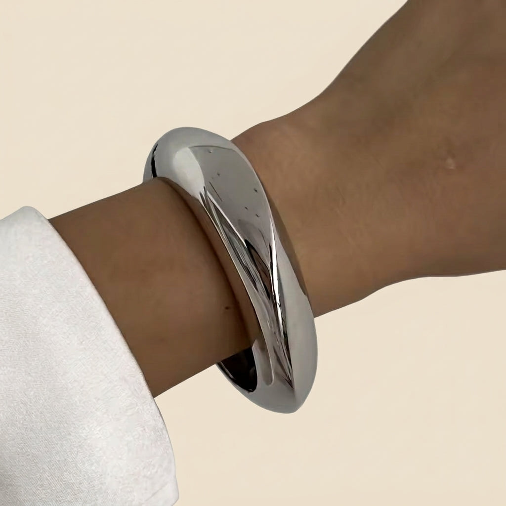 Sculptural Cuff Bangle - smooth dome, silver color, worn