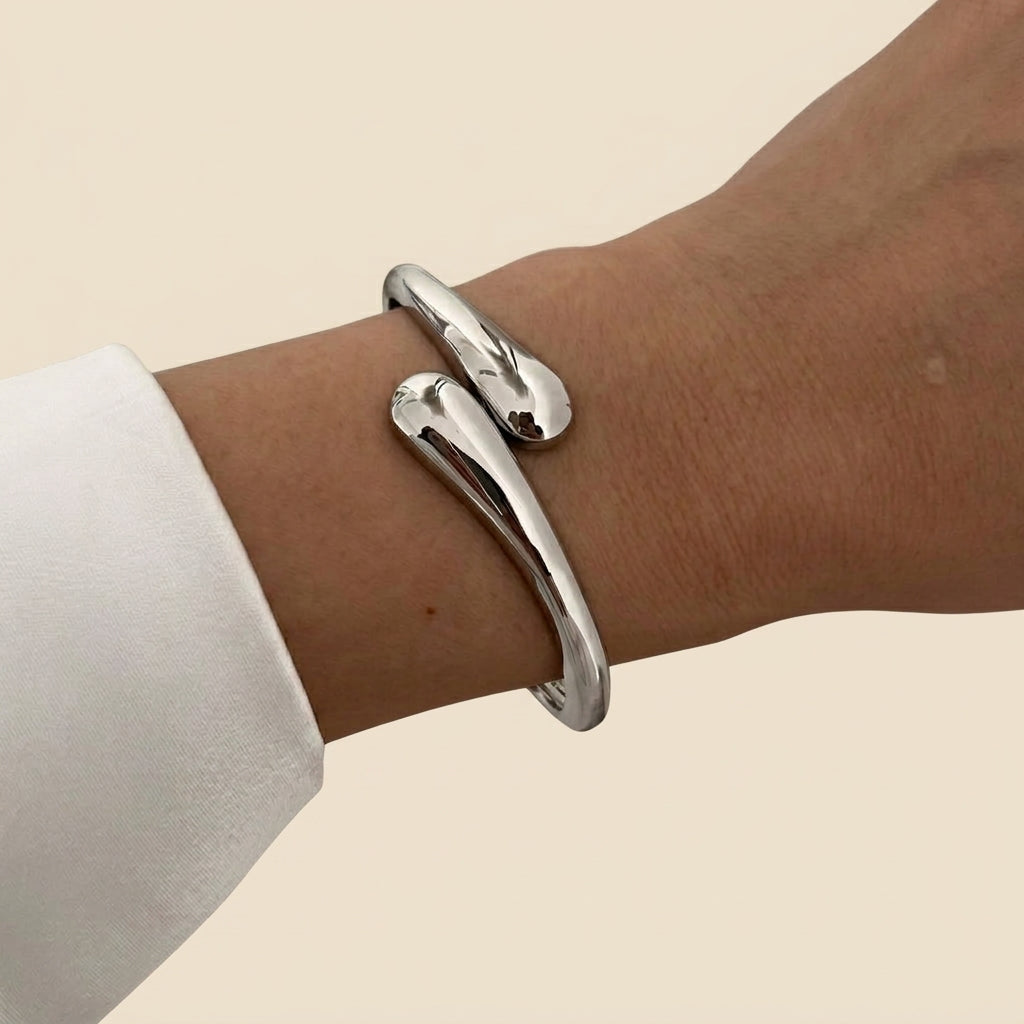 Sculptural Cuff Bangle - open wrap, silver color, worn