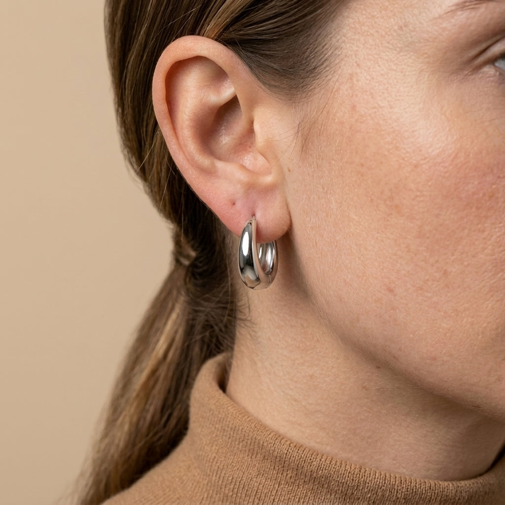 Minimalist Huggie Hoops - silver color, worn