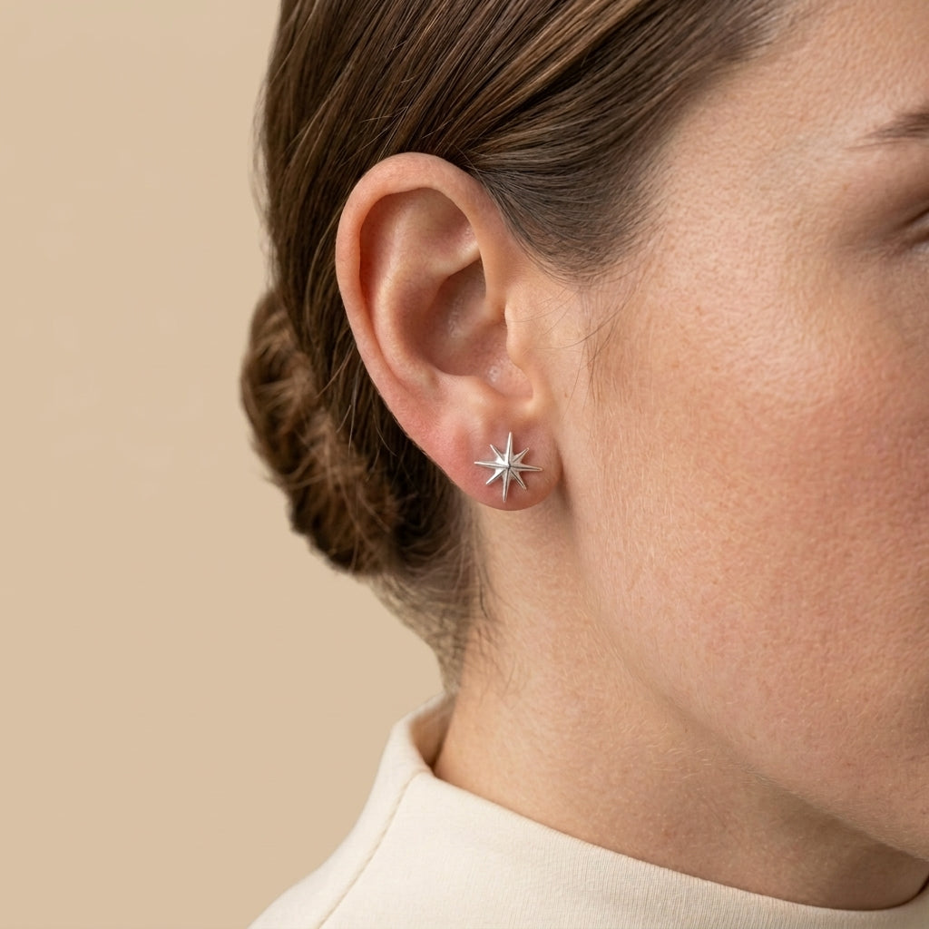 Mini Star Stud Earrings - silver color, worn